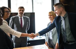 Business professionals shaking hands at a networking meeting